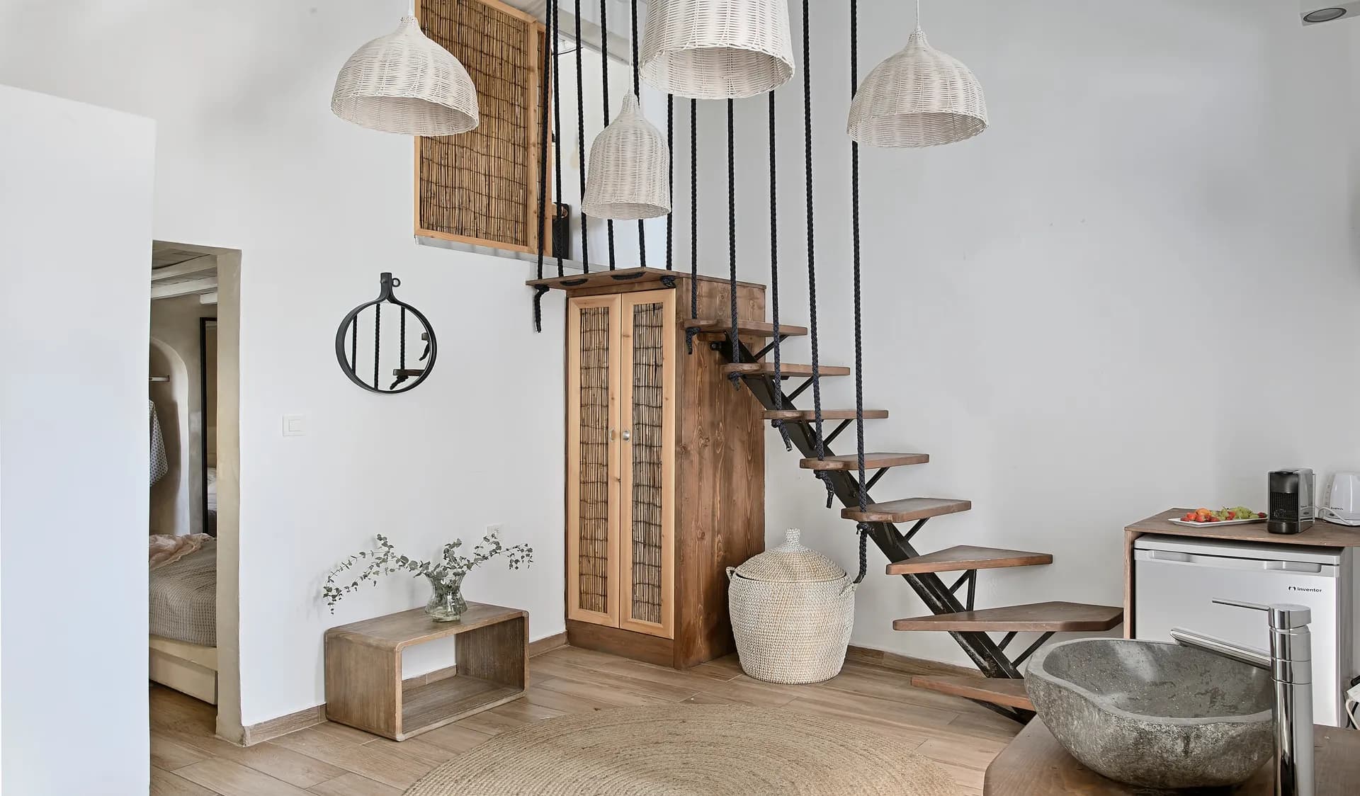 Open-plan maisonette with stone basin and staircase to the upper floor