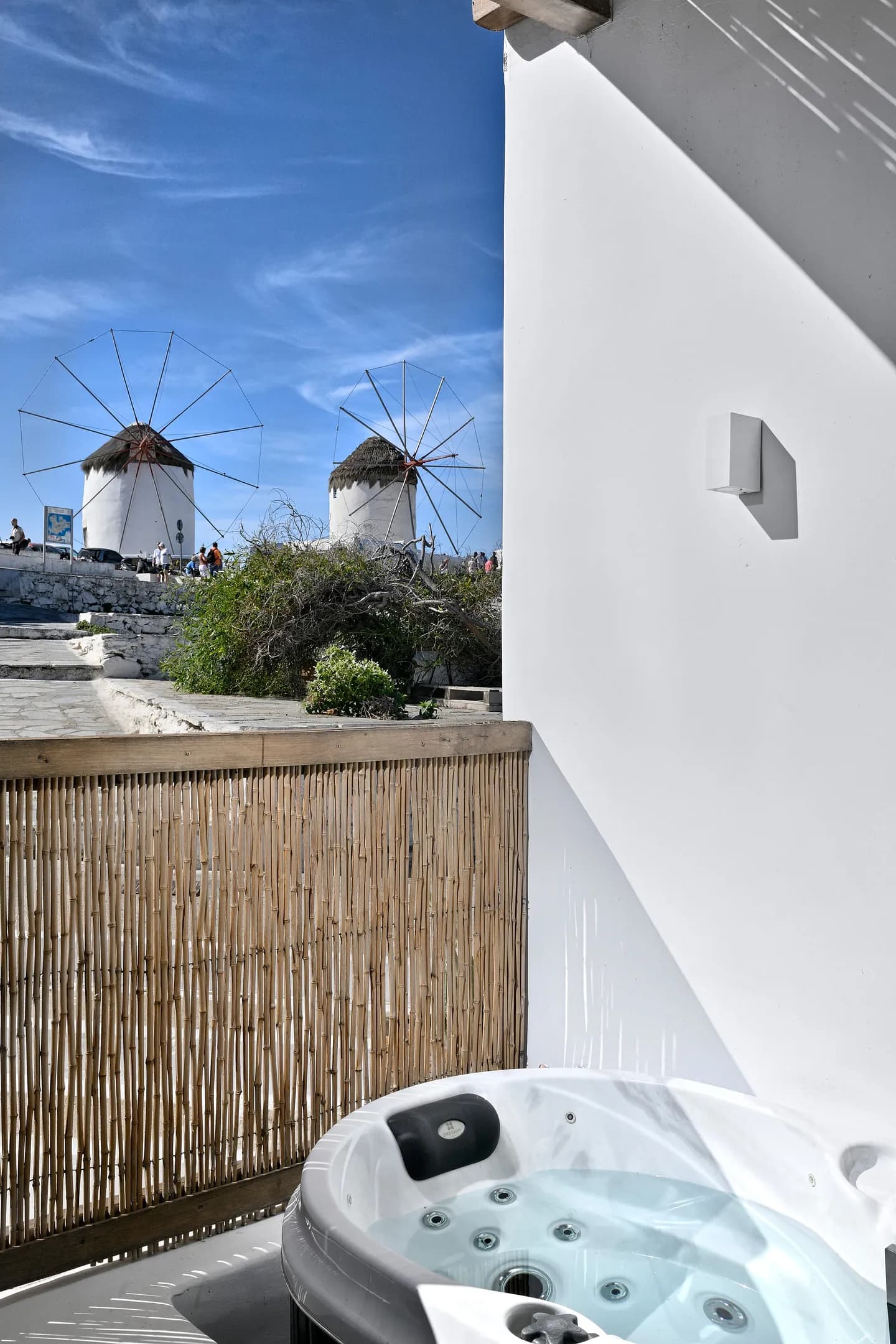 Outdoor hot tub on the veranda with the windmills behind