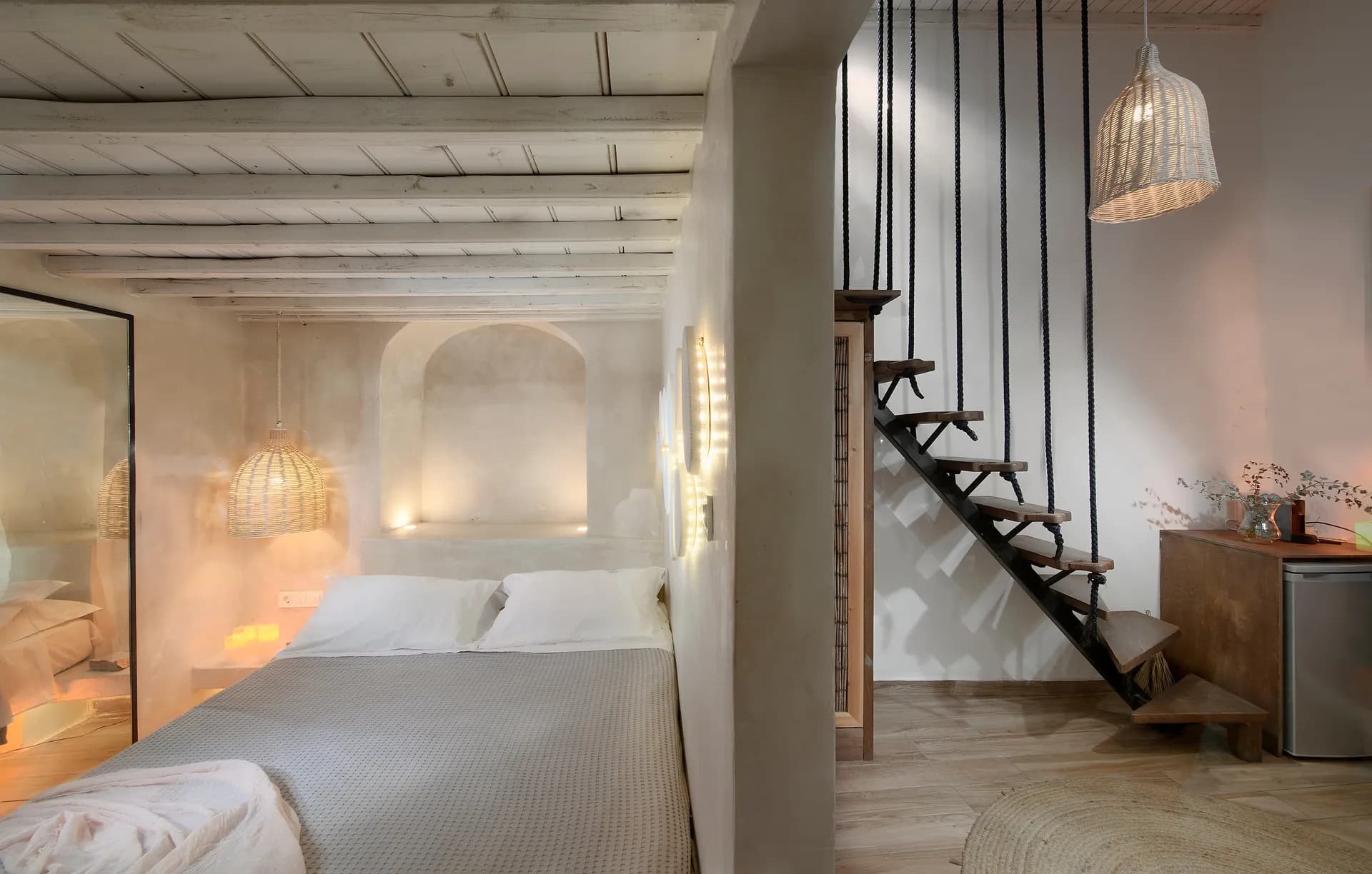 Maisonette bedroom with staircase and soft lighting