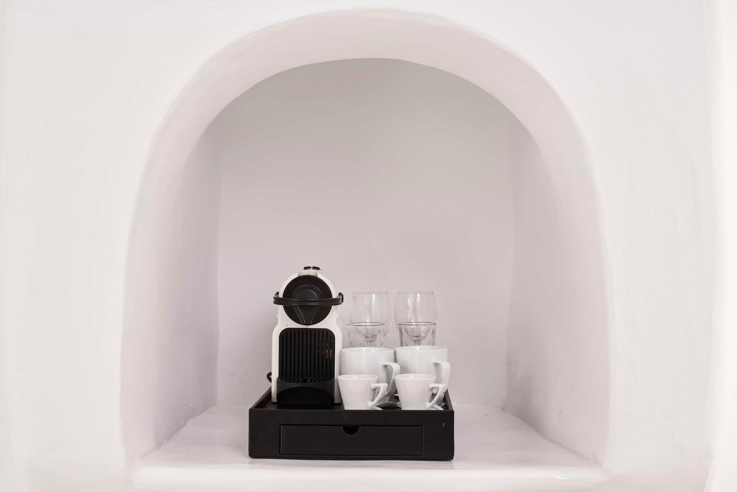 Coffee machine and cups in a whitewashed niche