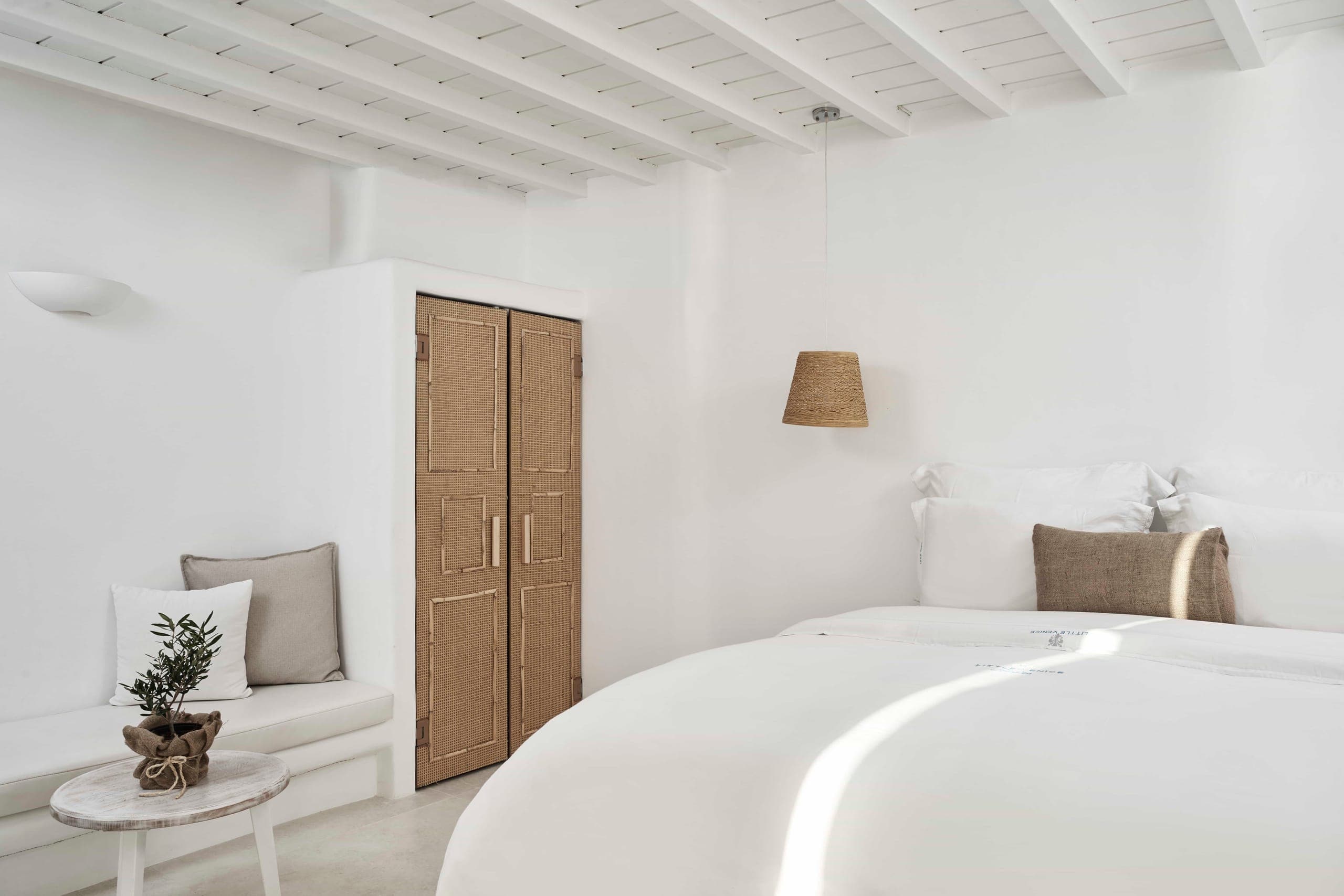Queen bed with built-in sofa and wooden wardrobe