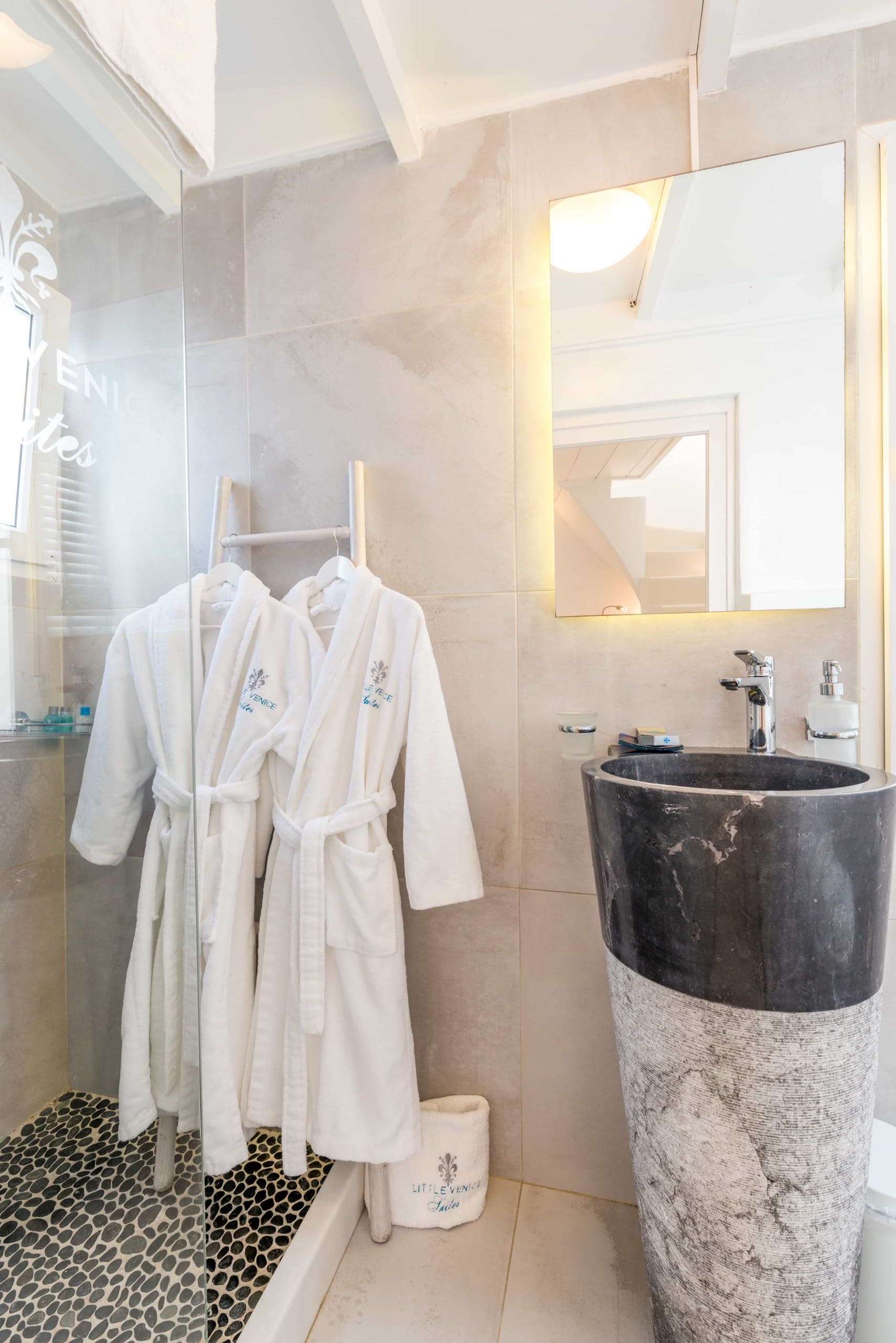 Bathroom with marble basin, rain shower and bathrobes