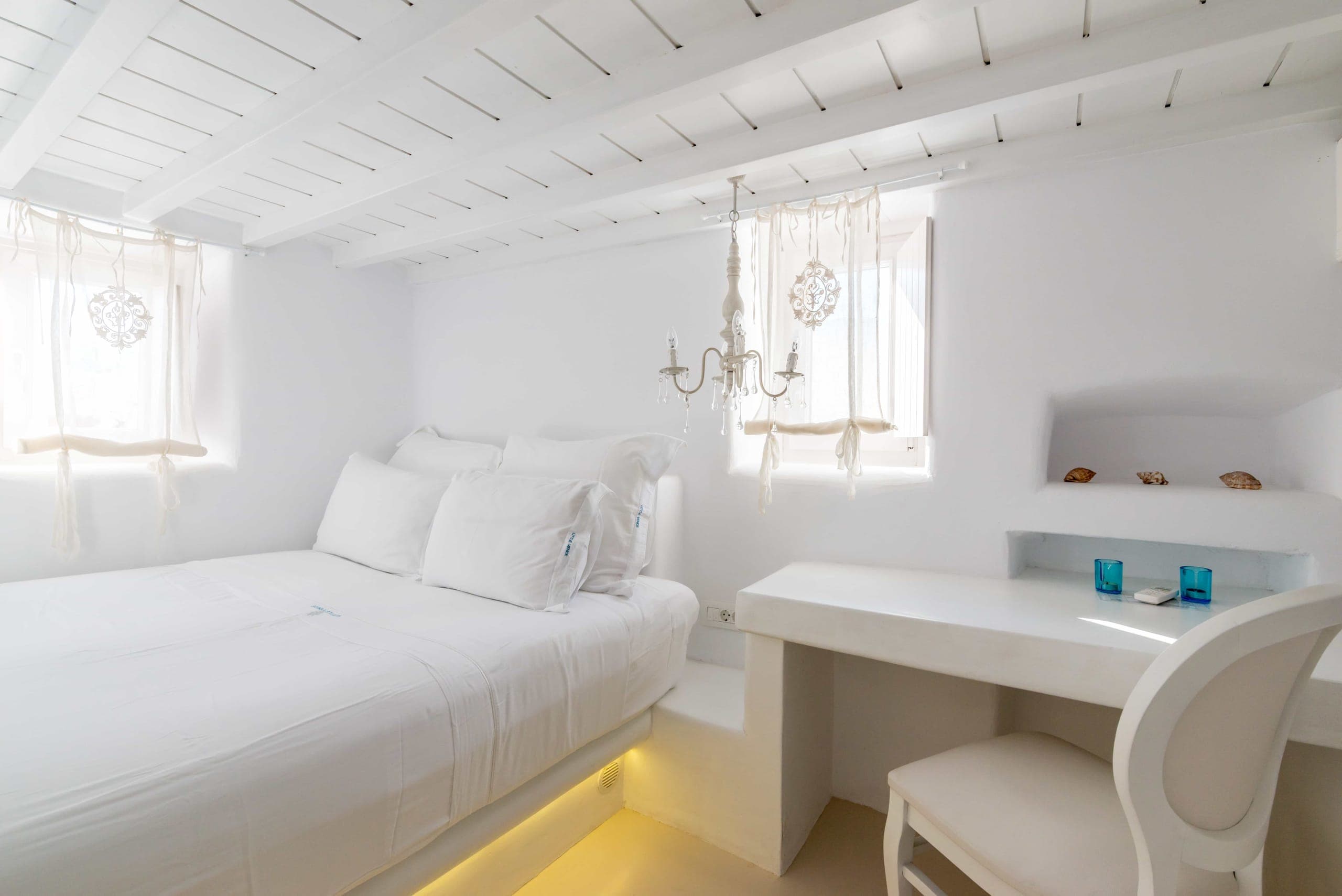 Bedroom with double bed, desk and soft lighting