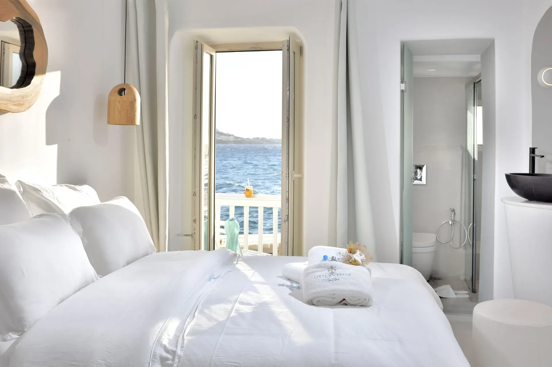 Bedroom with a door open to a sea-view balcony