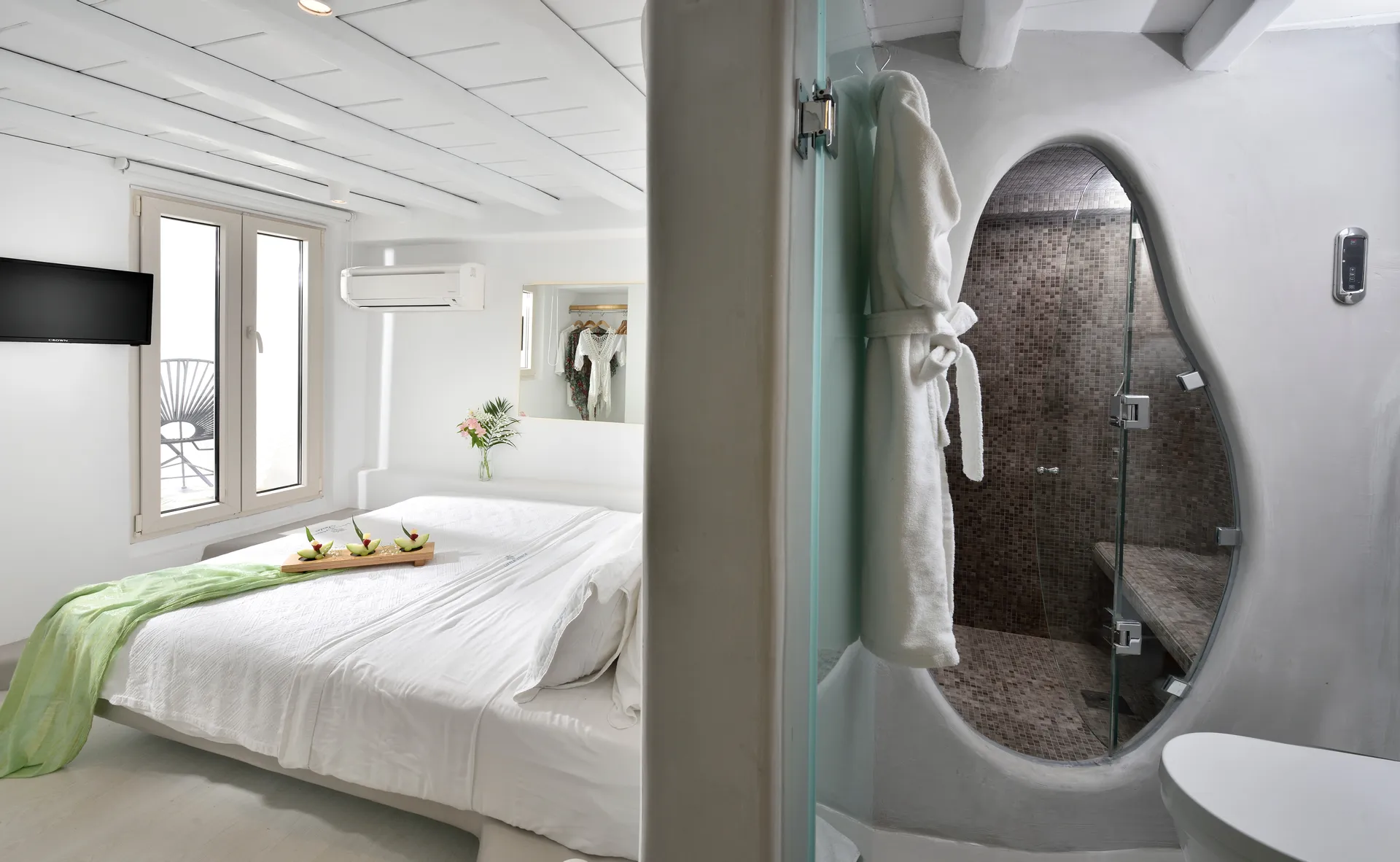 Bedroom next to a stone-tiled steam shower