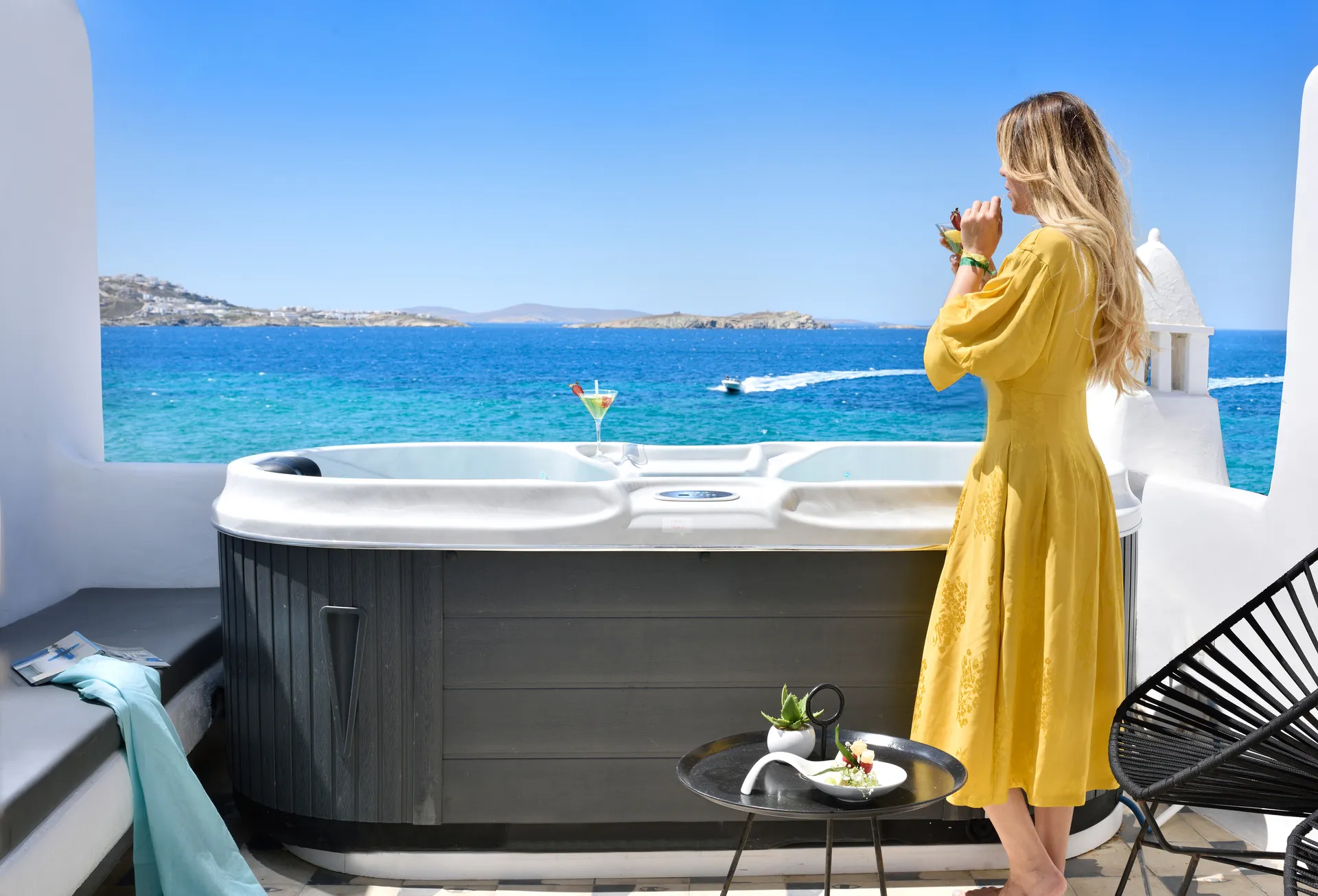 Guest beside the terrace Jacuzzi looking out to sea