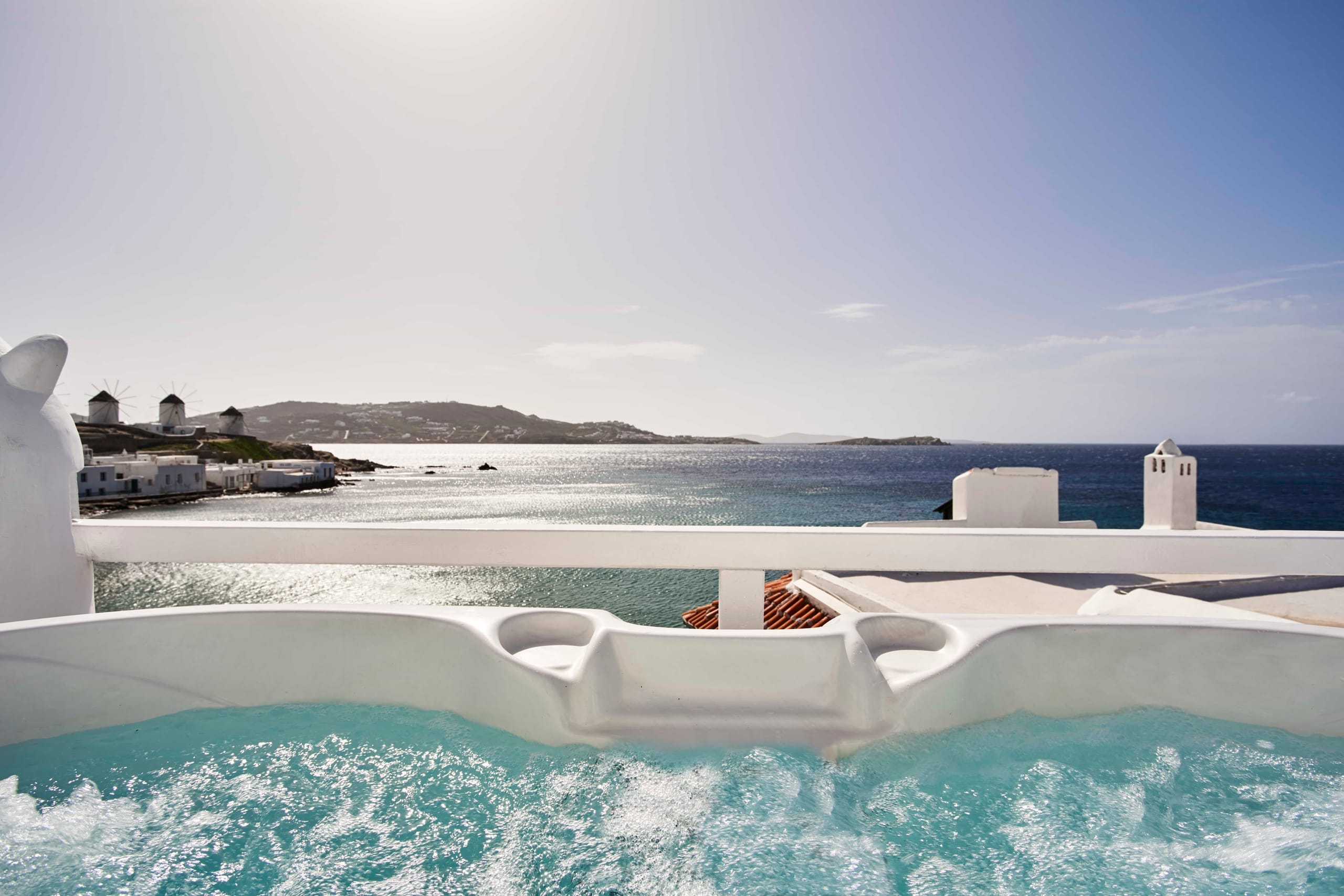 Outdoor hot tub on a private terrace overlooking the sea and the windmills