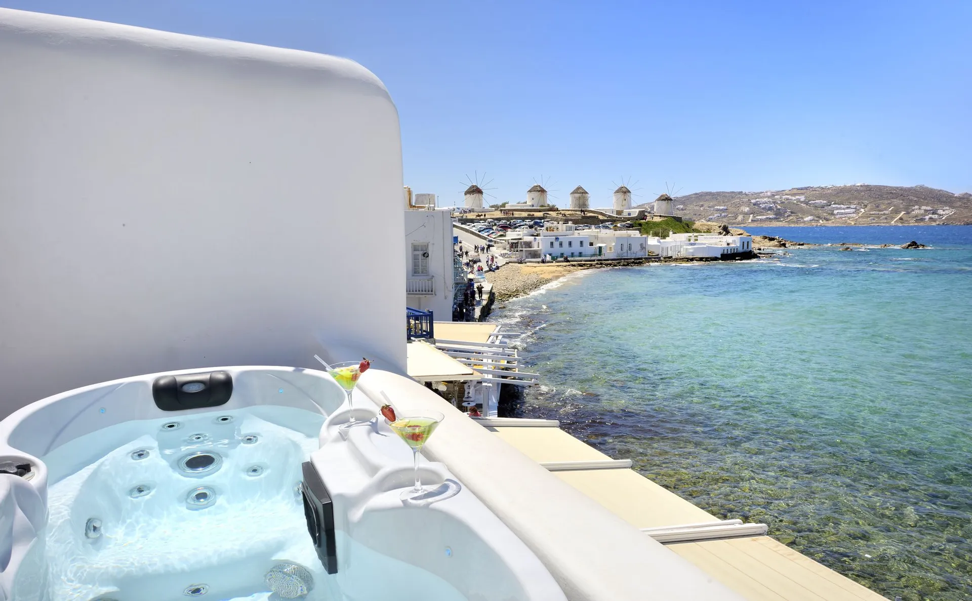 Outdoor Jacuzzi on a suite terrace overlooking the sea and the windmills of Mykonos